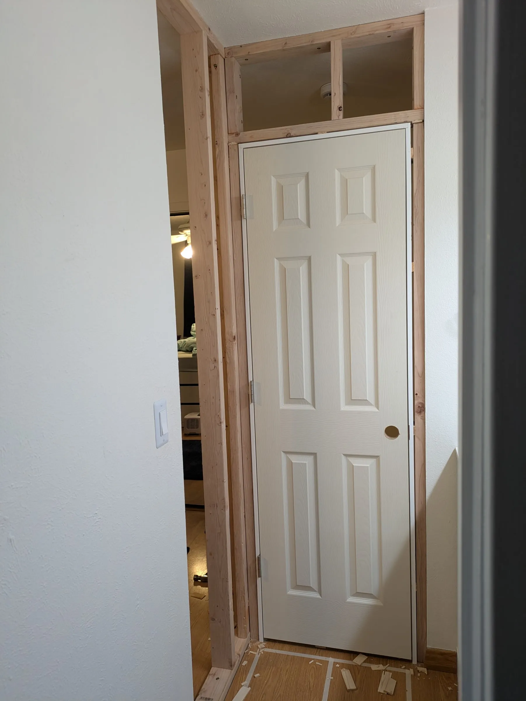The door hung in the frame, with the framed box above it