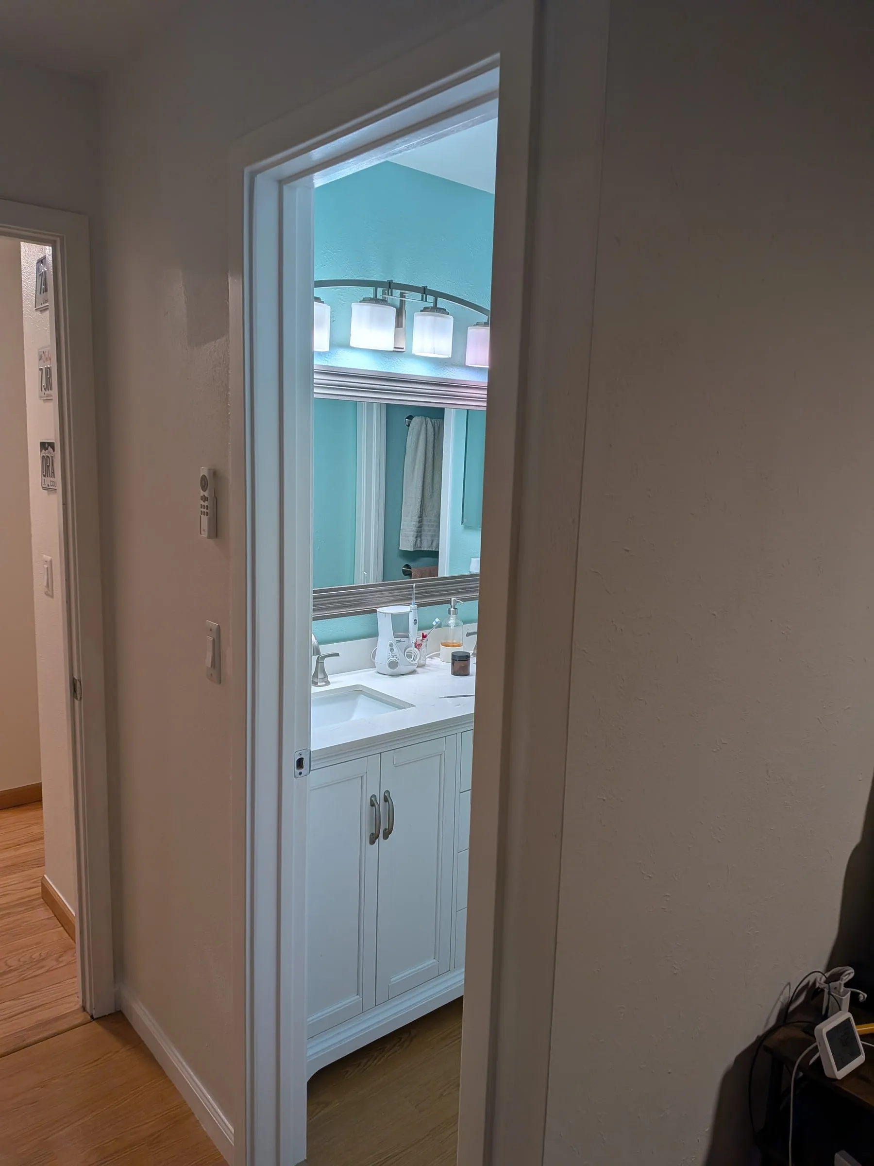 The trimmed doorway seen from the bedroom, looking through into the bathroom