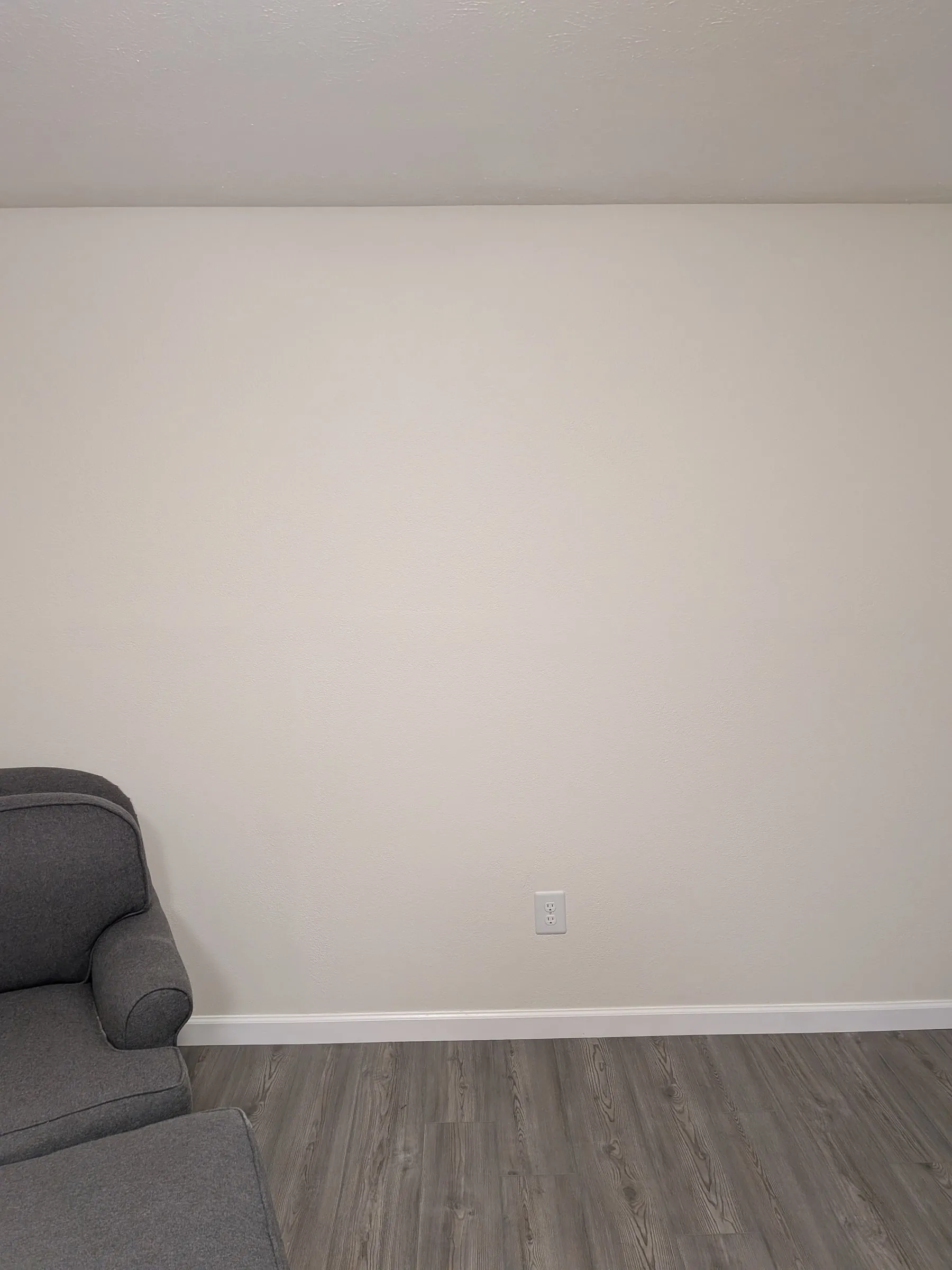The accent wall removed, patched, retextured and painted, with baseboards back in